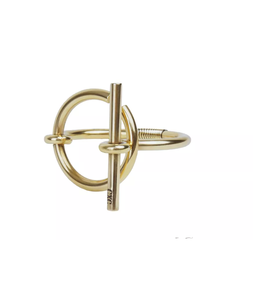 Pulsera Orígenes CXC, en metal bañado en oro.