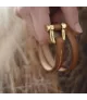Pulsera Grillete Roll CXC, en metal bañado en oro.