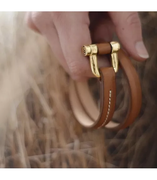 Pulsera Grillete Roll CXC, en metal bañado en oro.